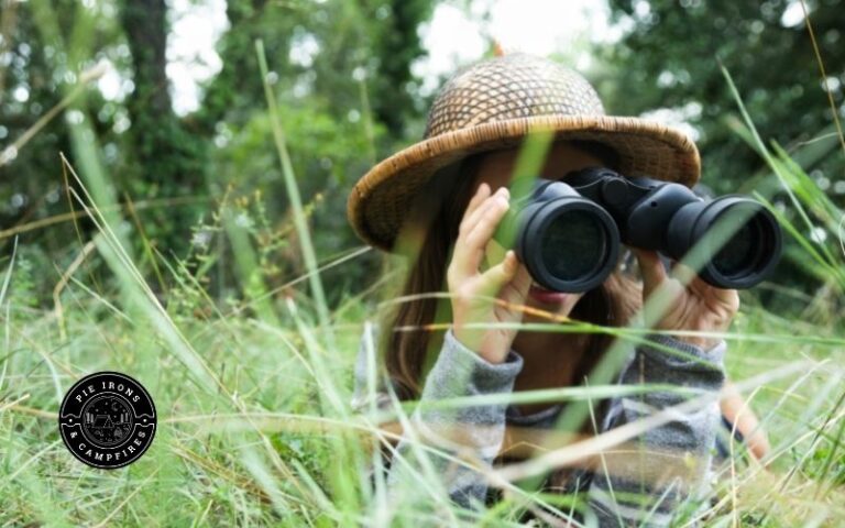Child Looking through binoculars to find birds.